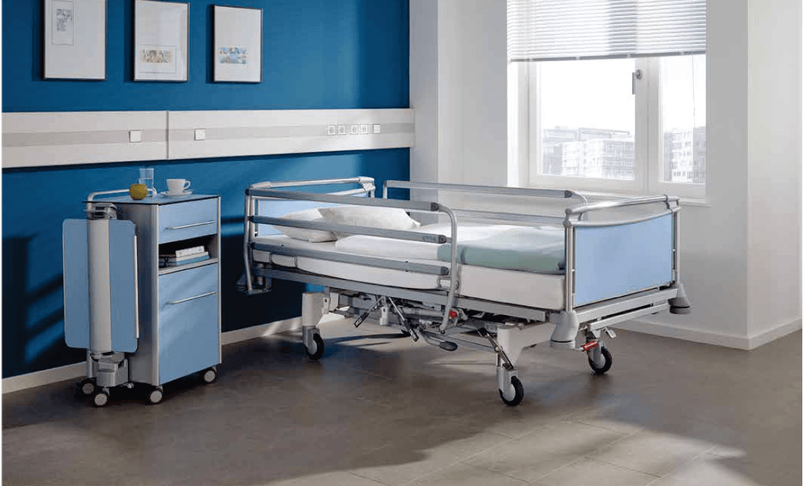 Hospital bed with bedside furniture in a contemporary ward room
